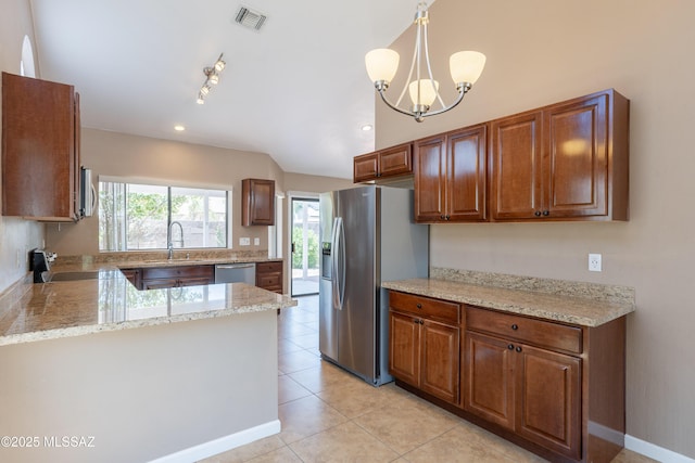 9701 N Camino Del Fierro, Tucson, AZ 85742 - kitchen featuring appliances with stainless steel finishes, a sink, light tile patterned floors, light stone counters, and a chandelier