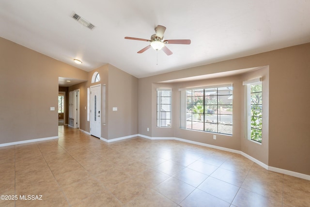 9701 N Camino Del Fierro, Tucson, AZ 85742 - unfurnished room featuring plenty of natural light, lofted ceiling, light tile patterned floors, a ceiling fan, and baseboards