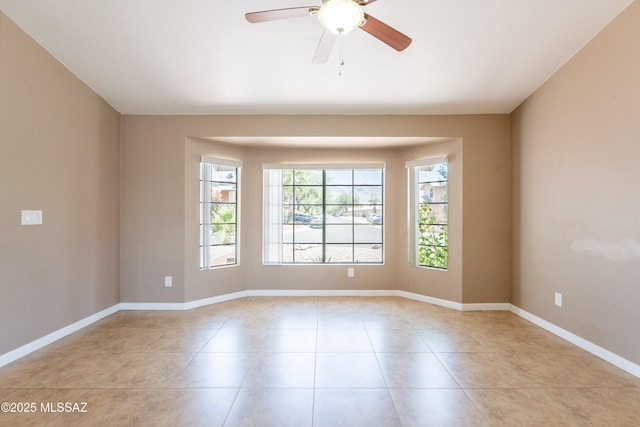 9701 N Camino Del Fierro, Tucson, AZ 85742 - spare room with light tile patterned flooring, a ceiling fan, and baseboards
