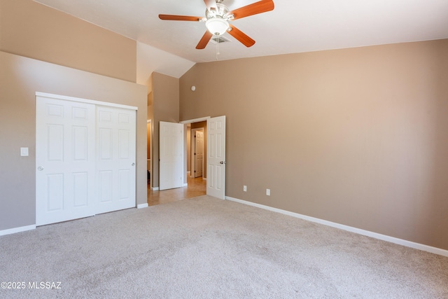9701 N Camino Del Fierro, Tucson, AZ 85742 - unfurnished bedroom featuring light colored carpet, baseboards, a closet, high vaulted ceiling, and a ceiling fan