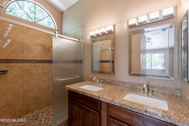 9701 N Camino Del Fierro, Tucson, AZ 85742 - bathroom with plenty of natural light, a stall shower, double vanity, vaulted ceiling, and a ceiling fan