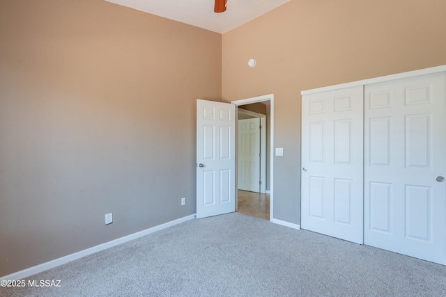 9701 N Camino Del Fierro, Tucson, AZ 85742 - unfurnished bedroom with carpet, high vaulted ceiling, baseboards, a closet, and a ceiling fan