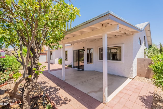 9701 N Camino Del Fierro, Tucson, AZ 85742 - back of house with stucco siding and a patio