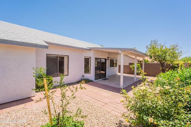 9701 N Camino Del Fierro, Tucson, AZ 85742 - rear view of house with stucco siding, a patio area, and a shingled roof