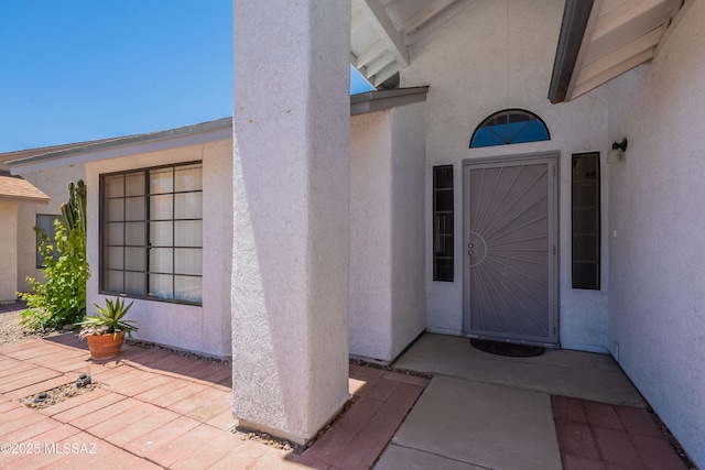 9701 N Camino Del Fierro, Tucson, AZ 85742 - doorway to property featuring stucco siding and a patio area