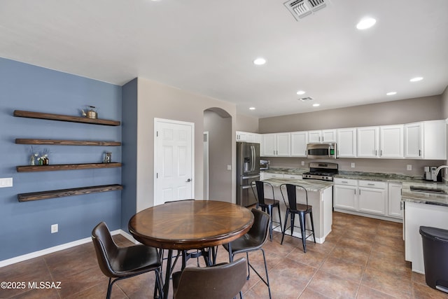 19 W Via Teresita, Sahuarita, AZ 85629 - tiled dining room featuring a sink, arched walkways, recessed lighting, and baseboards