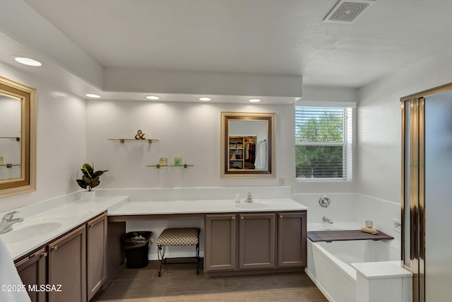 19 W Via Teresita, Sahuarita, AZ 85629 - full bathroom featuring vanity, a bath, wood finished floors, and recessed lighting