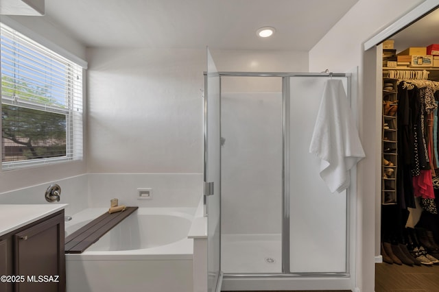 19 W Via Teresita, Sahuarita, AZ 85629 - full bathroom featuring a bath, a spacious closet, a stall shower, vanity, and recessed lighting