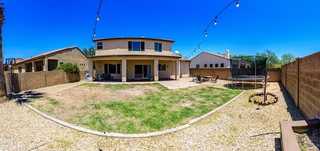 19 W Via Teresita, Sahuarita, AZ 85629 - rear view of property with stucco siding, a trampoline, a patio area, and a fenced backyard