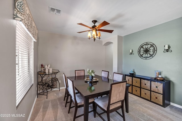 19 W Via Teresita, Sahuarita, AZ 85629 - carpeted dining space featuring ceiling fan, arched walkways, and baseboards