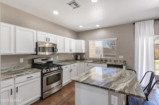 19 W Via Teresita, Sahuarita, AZ 85629 - kitchen featuring appliances with stainless steel finishes, a sink, light stone countertops, white cabinetry, and recessed lighting