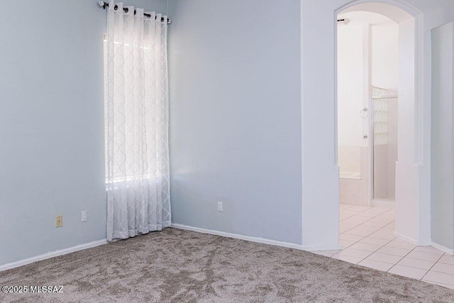 161 N Carlilse Way, Willcox, AZ 85643 - carpeted spare room with arched walkways, tile patterned floors, and baseboards