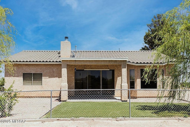 161 N Carlilse Way, Willcox, AZ 85643 - back of house featuring a chimney, stucco siding, and a tiled roof