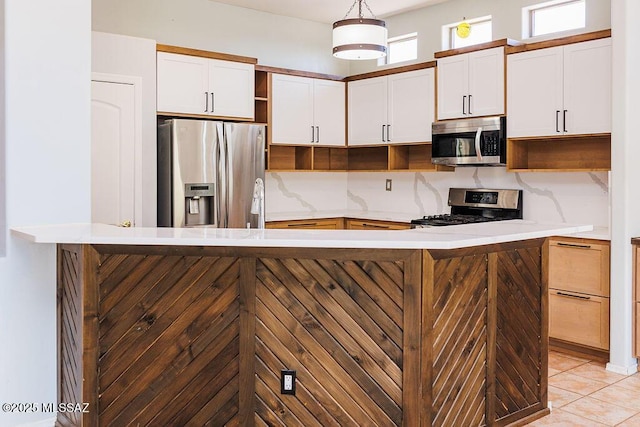 161 N Carlilse Way, Willcox, AZ 85643 - kitchen with open shelves, stainless steel appliances, light countertops, hanging light fixtures, and white cabinets