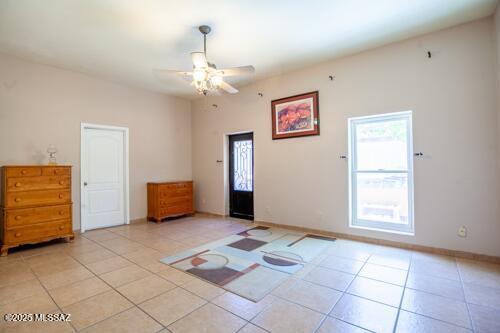 480 Camino Ramanote, Rio Rico, AZ 85648 - unfurnished room featuring light tile patterned flooring, a ceiling fan, and baseboards