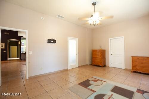 480 Camino Ramanote, Rio Rico, AZ 85648 - unfurnished bedroom featuring tile patterned floors and a ceiling fan