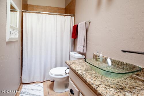 480 Camino Ramanote, Rio Rico, AZ 85648 - bathroom with vanity, toilet, a shower with shower curtain, and tile patterned floors