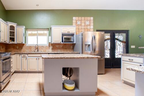 480 Camino Ramanote, Rio Rico, AZ 85648 - kitchen with french doors, stainless steel appliances, light tile patterned flooring, and a sink