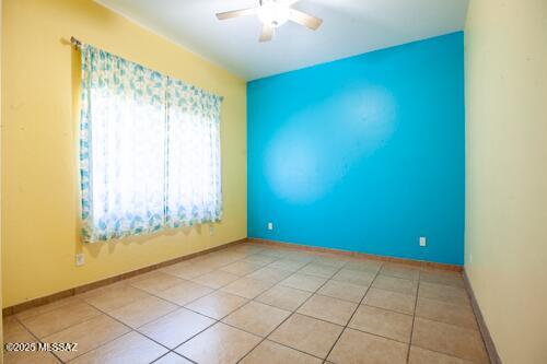 480 Camino Ramanote, Rio Rico, AZ 85648 - unfurnished room with ceiling fan, light tile patterned floors, and baseboards