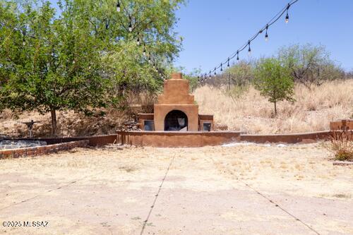 480 Camino Ramanote, Rio Rico, AZ 85648 - view of patio / terrace featuring an outdoor fireplace