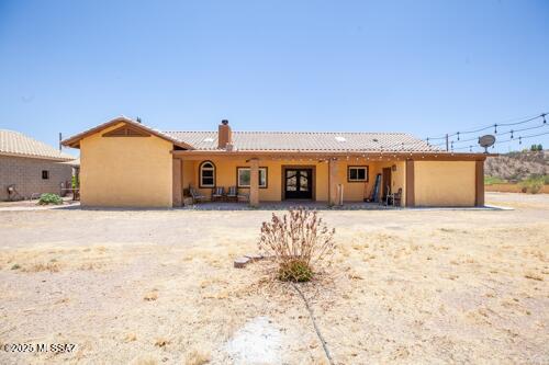 480 Camino Ramanote, Rio Rico, AZ 85648 - back of property featuring a chimney, stucco siding, and a tile roof