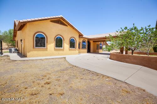 480 Camino Ramanote, Rio Rico, AZ 85648 - view of front of house with stucco siding and curved driveway