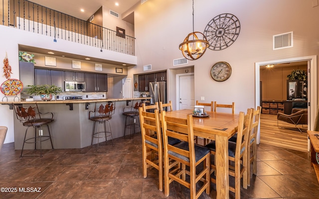 9387 S Via Famero, Vail, AZ 85641 - dining space featuring a high ceiling and a chandelier