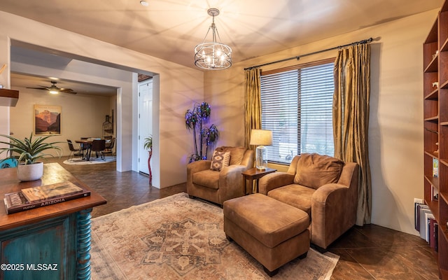 9387 S Via Famero, Vail, AZ 85641 - sitting room with a chandelier, a ceiling fan, and dark tile patterned flooring