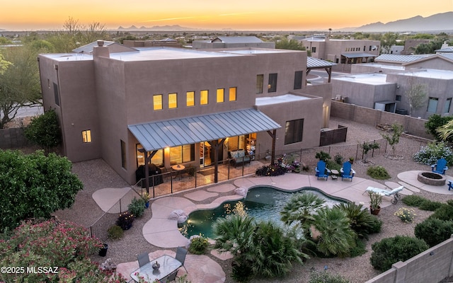 9387 S Via Famero, Vail, AZ 85641 - back of property with stucco siding, a patio, a fenced backyard, and an outdoor fire pit
