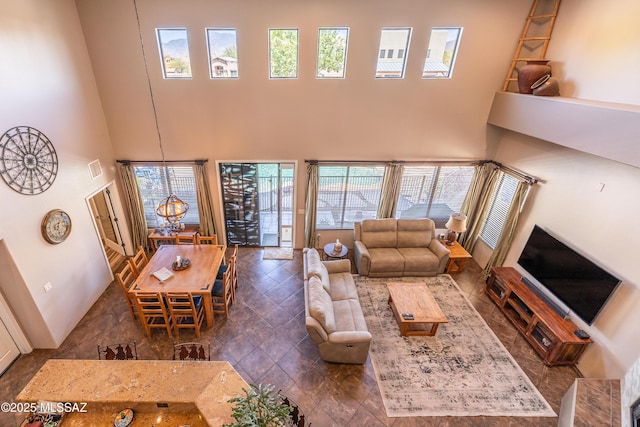 9387 S Via Famero, Vail, AZ 85641 - living area featuring a high ceiling, healthy amount of natural light, and a chandelier