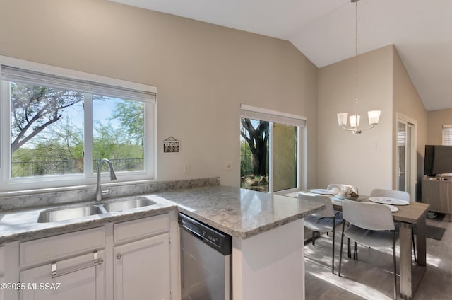 11561 N Eagle Peak Dr, Oro Valley, AZ 85737 - kitchen featuring stainless steel dishwasher, a sink, lofted ceiling, a chandelier, and white cabinets