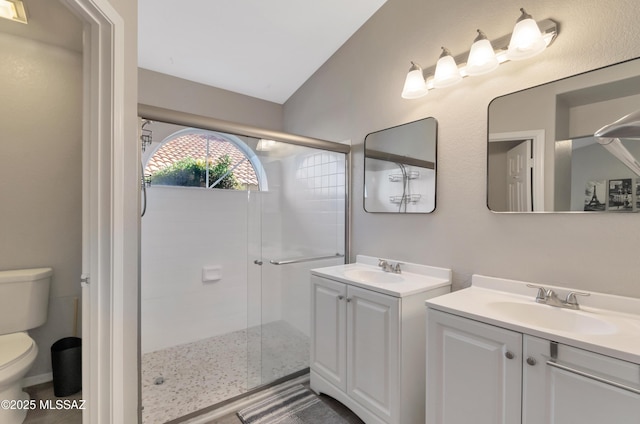 11561 N Eagle Peak Dr, Oro Valley, AZ 85737 - bathroom with a stall shower, toilet, two vanities, and lofted ceiling