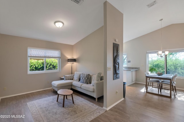 11561 N Eagle Peak Dr, Oro Valley, AZ 85737 - living area featuring healthy amount of natural light, wood finished floors, a chandelier, and high vaulted ceiling
