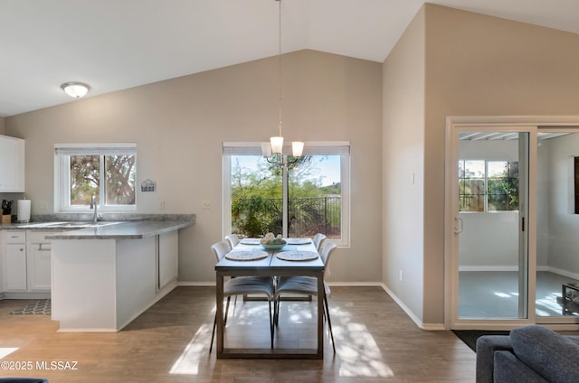 11561 N Eagle Peak Dr, Oro Valley, AZ 85737 - dining space with a chandelier, healthy amount of natural light, light wood-type flooring, and high vaulted ceiling