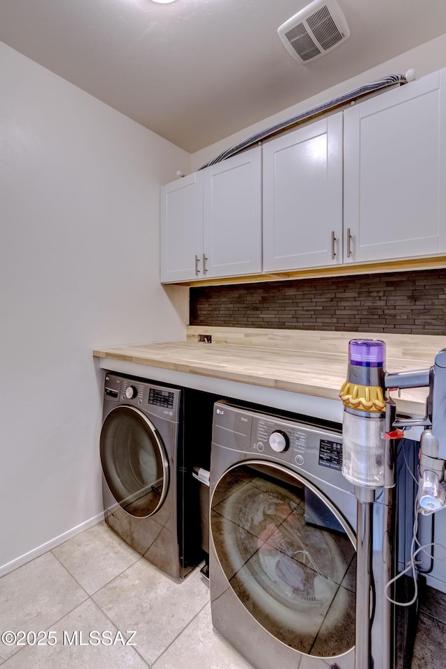 9978 N Niobrara Way, Tucson, AZ 85742 - washroom featuring cabinet space, separate washer and dryer, light tile patterned floors, and baseboards