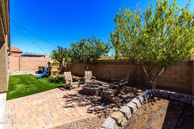 9978 N Niobrara Way, Tucson, AZ 85742 - view of patio / terrace with an outdoor fire pit and a playground