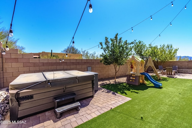 9978 N Niobrara Way, Tucson, AZ 85742 - view of yard featuring a hot tub, a patio area, and a playground