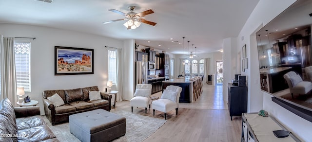 9978 N Niobrara Way, Tucson, AZ 85742 - living room with healthy amount of natural light, a ceiling fan, and light wood-style floors