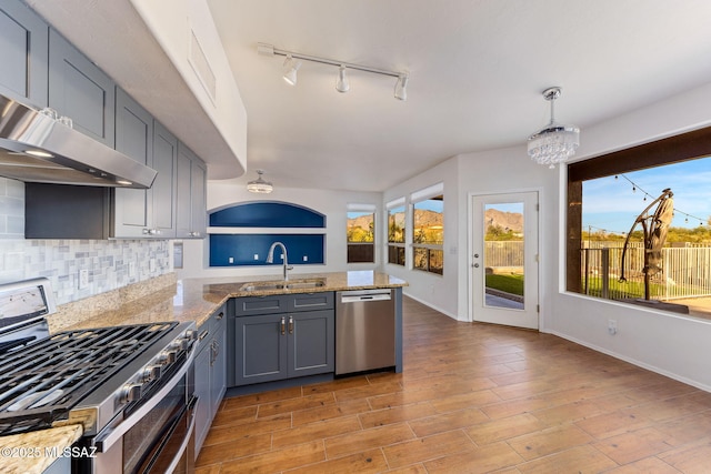 11262 N Chynna Rose Pl, Oro Valley, AZ 85737 - kitchen with appliances with stainless steel finishes, a sink, a peninsula, rail lighting, and gray cabinetry