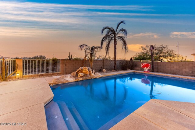 11262 N Chynna Rose Pl, Oro Valley, AZ 85737 - pool at dusk featuring a fenced backyard