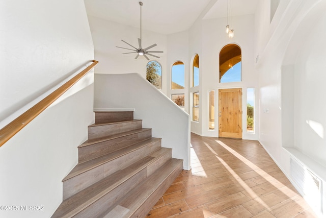 11262 N Chynna Rose Pl, Oro Valley, AZ 85737 - staircase featuring a high ceiling, hardwood / wood-style floors, and a ceiling fan