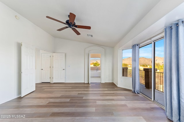 11262 N Chynna Rose Pl, Oro Valley, AZ 85737 - empty room featuring vaulted ceiling, ceiling fan, wood finished floors, and a smoke detector