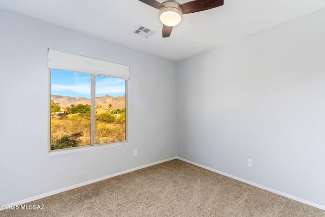 11262 N Chynna Rose Pl, Oro Valley, AZ 85737 - empty room featuring carpet, ceiling fan, baseboards, and a mountain view