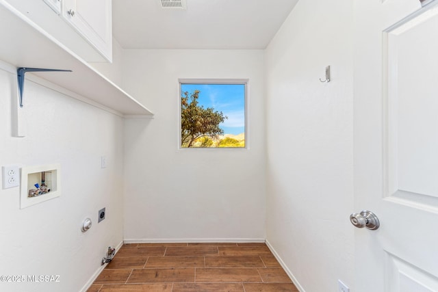 11262 N Chynna Rose Pl, Oro Valley, AZ 85737 - laundry area with wood finished floors, hookup for a washing machine, cabinet space, hookup for an electric dryer, and baseboards