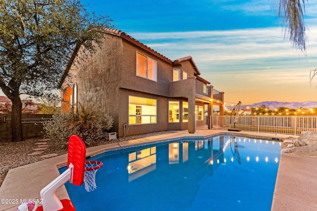 11262 N Chynna Rose Pl, Oro Valley, AZ 85737 - pool at dusk with a fenced backyard and a mountain view