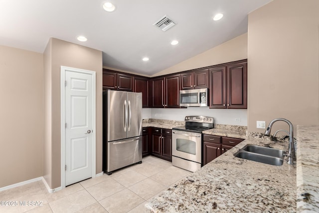 4099 E Shadow Branch Dr, Tucson, AZ 85756 - kitchen with stainless steel appliances, a sink, light stone countertops, dark brown cabinetry, and light tile patterned flooring