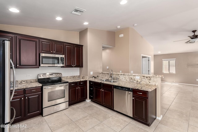 4099 E Shadow Branch Dr, Tucson, AZ 85756 - kitchen featuring stainless steel appliances, a sink, light tile patterned floors, a peninsula, and light stone counters