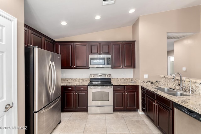 4099 E Shadow Branch Dr, Tucson, AZ 85756 - kitchen with stainless steel appliances, a sink, lofted ceiling, light tile patterned floors, and light stone counters