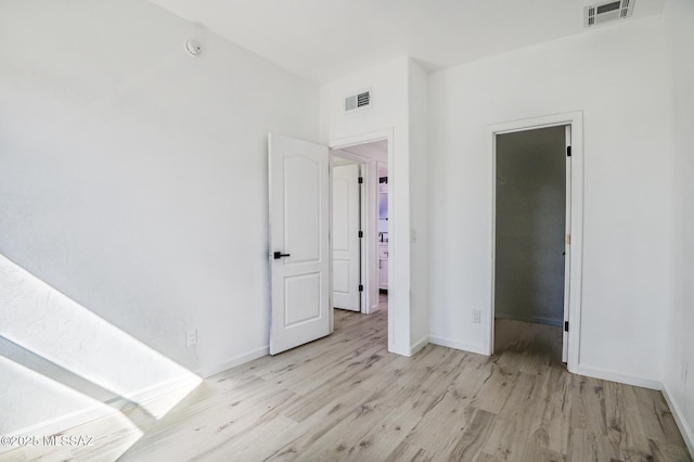 185 E Calle Zavala, Tucson, AZ 85704 - unfurnished bedroom featuring wood finished floors and baseboards
