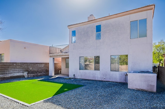 185 E Calle Zavala, Tucson, AZ 85704 - back of property featuring a balcony, a fenced backyard, a chimney, and stucco siding